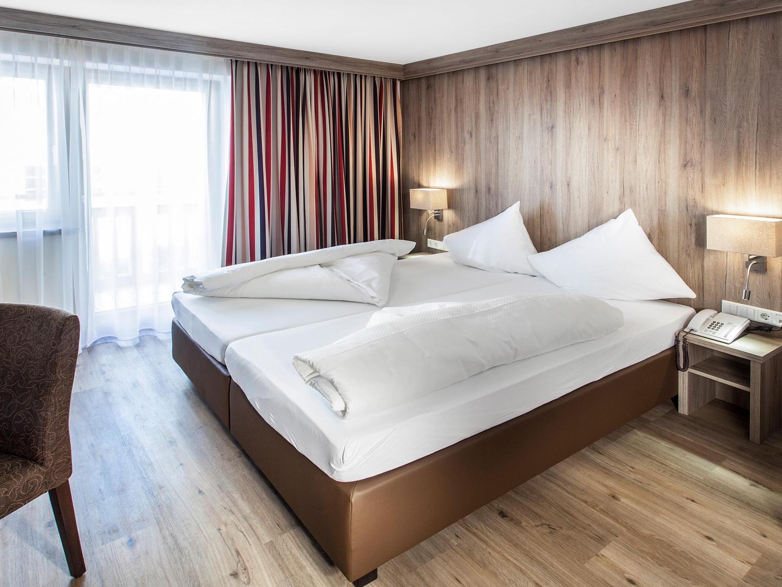 Room with pine wainscoting at 4-star Hotel Reiterkogel