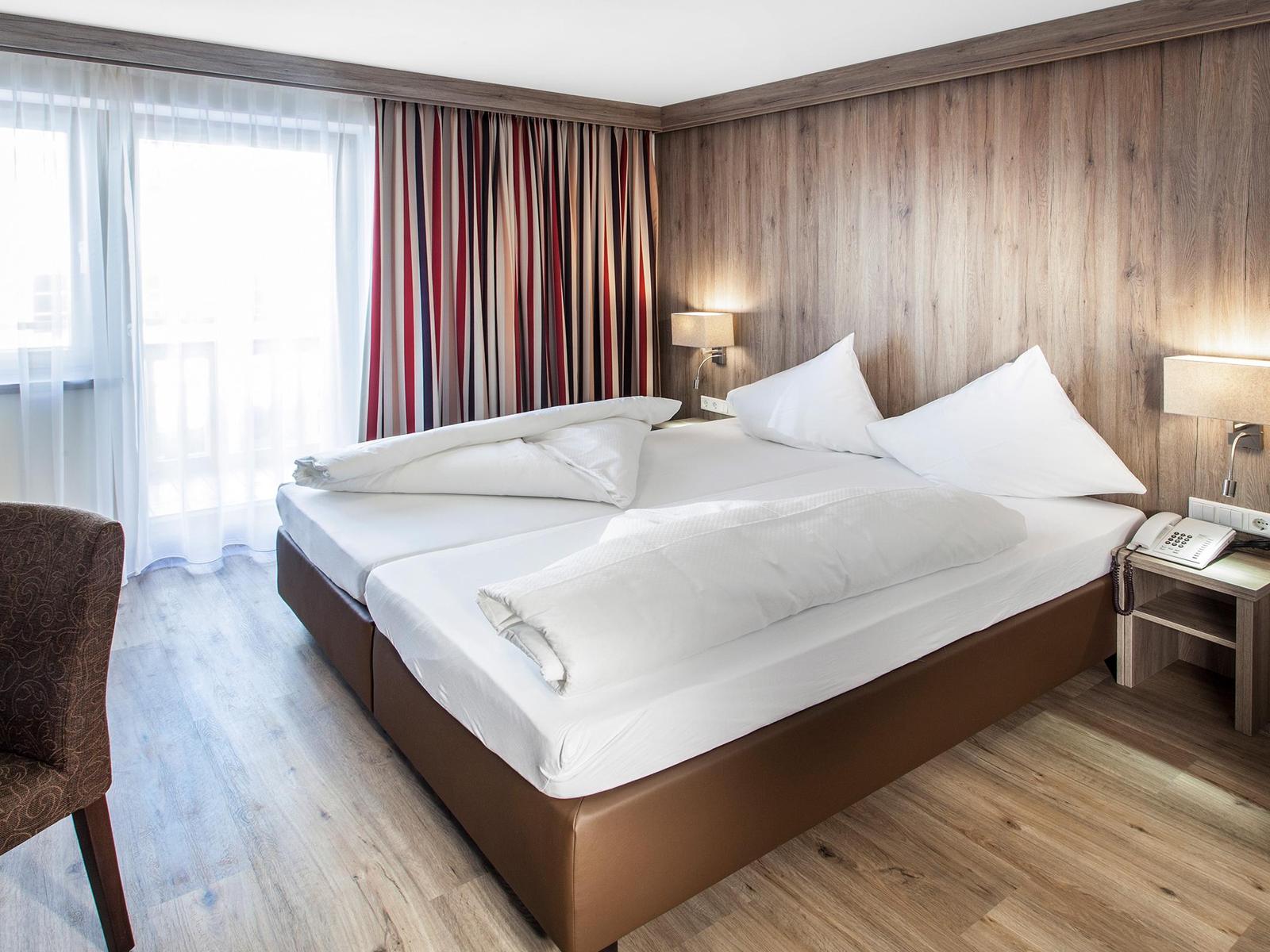 Room with pine wainscoting at 4-star Hotel Reiterkogel